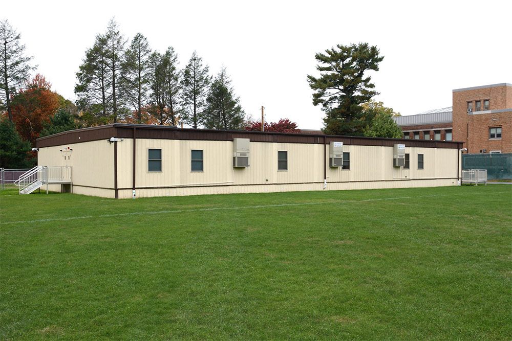 A large grassy field in Pedricktown, NJ, showcasing the area for the Section Modular Office project